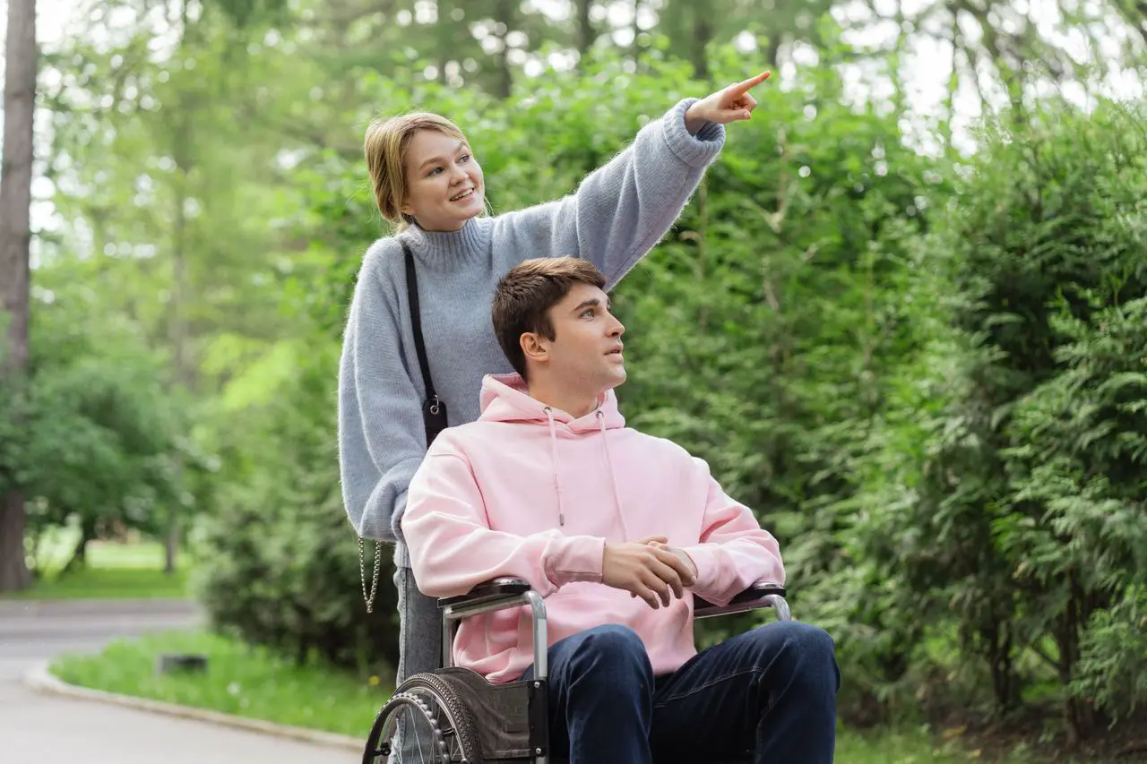 Person using a wheelchair receiving support to participate in the community