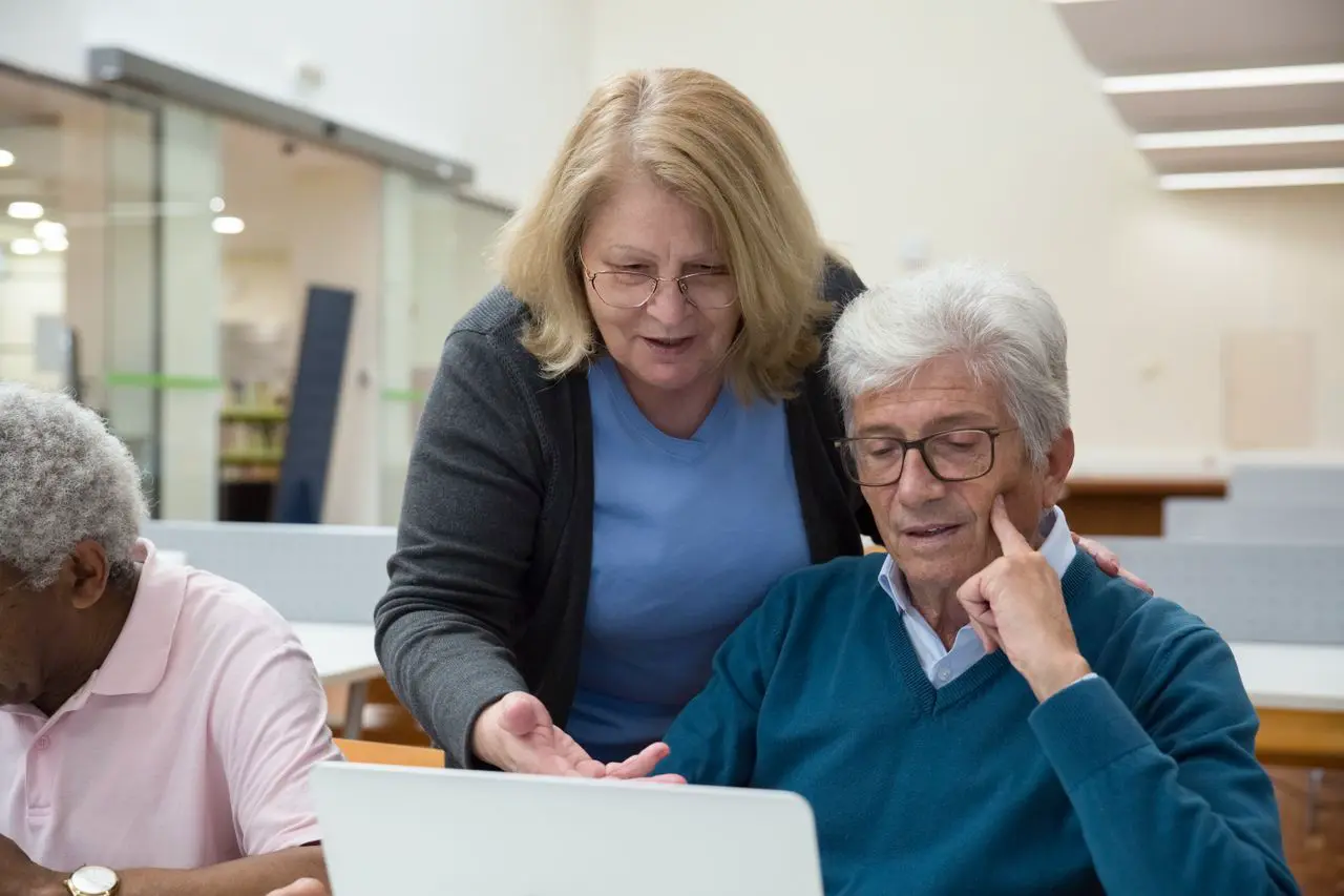Support worker helping an older adult build confidence with everyday communication